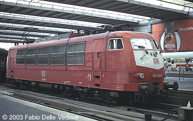 Zum Vergrößern klicken - 103 135-0 wurde bereits von den IR-Wagen abgekuppelt. Auf der Führerstandsseite 2 trägt sie das neue DB-Logo (München Hauptbahnhof, September 2002).